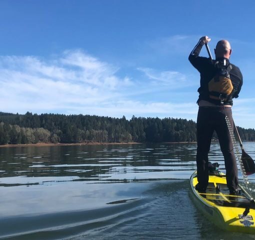 A stand-up paddleboarder is shown wearing a life jacket with a quick-release leash. State officials are warning residents to be careful on the water this holiday weekend.