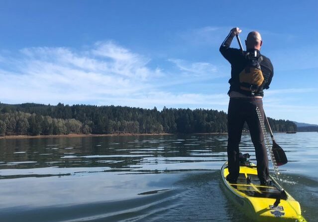 A stand-up paddleboarder is shown wearing a life jacket with a quick-release leash. State officials are warning residents to be careful on the water this holiday weekend.