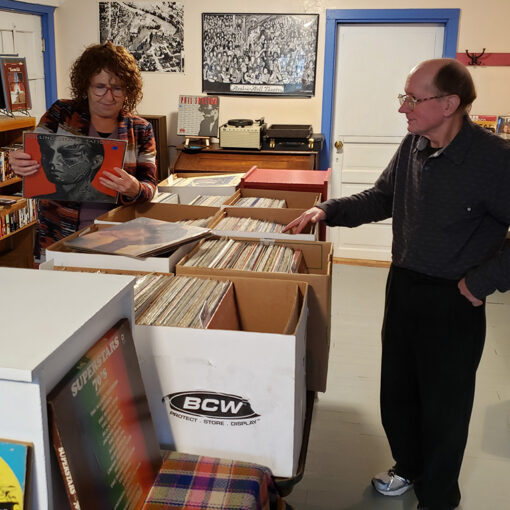 Vanessa Riley, left, and Randall Craig work on stocking the new RPM Records store in Mill City. The store focuses mainly on vinyl but offers cassettes, CDs and DVDs as well.