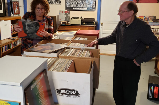Vanessa Riley, left, and Randall Craig work on stocking the new RPM Records store in Mill City. The store focuses mainly on vinyl but offers cassettes, CDs and DVDs as well.
