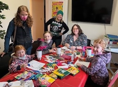 Rosy Ridderfrom Scio, left, and her daughters, Emory, Elsie, and Evelyn enjoy Willamette Connections Academy’s Book Fair while visiting with teachers Brittney Young and Janis Campbell.