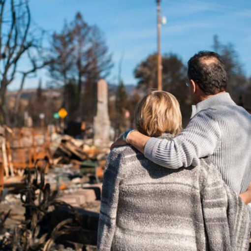 A couple review a home following the 2020 fires. For many, rebuilding is ongoing.