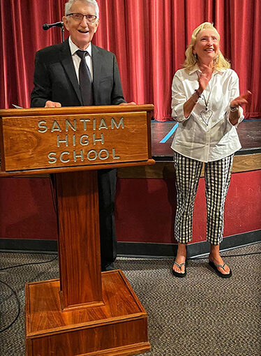 The late Mike Long, left, is the Citizen of the Year for the Santiam Canyon. Chamber past president Sandy Lyness, right, stands with him as he announces YBGT award winners at a previous awards night.