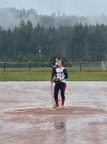Santiam pitcher Savannah Stanley stands in the circle amid a very wet infield in a recent game against Colton. The Wolverines have battled into playoff contention in Special District 2. Submitted Photo.