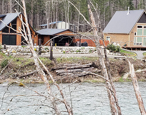 Newly constructed homes are shown along the Little North Santiam River in the Elkhorn area. State fire officials are encouraging residents to use this month to create defensible space around their homes. JAMES DAY