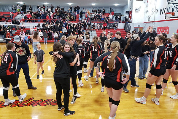 Students and players celebrate Oct. 28, after the Santiam volleyball squad advanced to the Class 2A state tournament with a 3-set win against Clatskanie. James Day