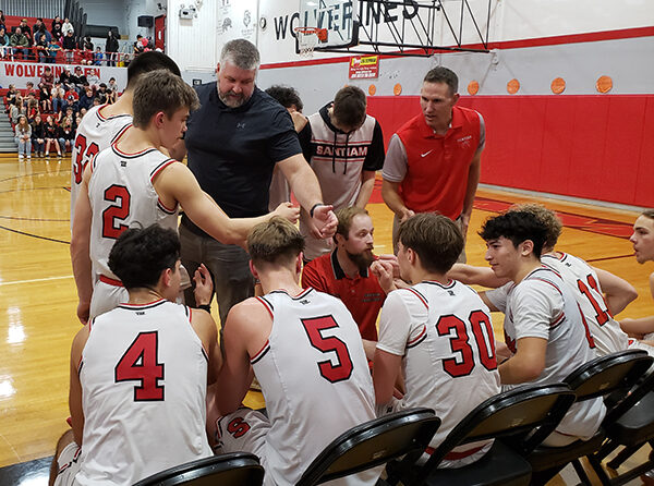 The Santiam boys basketball team gets set to come out of a huddle on Feb. 2 against Regis. At center is coach J.D. Hill. Promising newcomers playing key roles on this year’s squad are Mason Lindemann (2), Owen Rupert (5) and Kross Martinson (30). At left is veteran standout Xavier Vital (4). Assistant coach Julian Downey, kneeling at center, helped lead Hill’s 2017 team to a Class 2A title in 2017. James Day