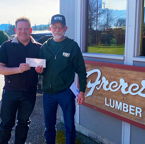 Tyler Freres of the Freres Lumber Company, presented Jeff Keto, treasurer of Santiam Hearts to Arts and KYAC Community Radio, a check for $3,000 to assure complete funding for the station’s Emergency Alert System.  SUBMITTED PHOTO