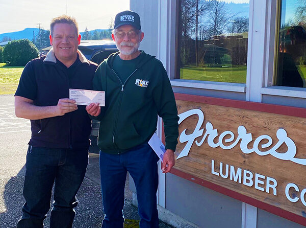 Tyler Freres of the Freres Lumber Company, presented Jeff Keto, treasurer of Santiam Hearts to Arts and KYAC Community Radio, a check for $3,000 to assure complete funding for the station’s Emergency Alert System.  SUBMITTED PHOTO