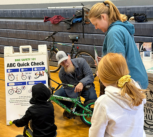Volunteers assist individuals with bicycle checks during a 2023 Seasons of Safety event. SUBMITTED PHOTO