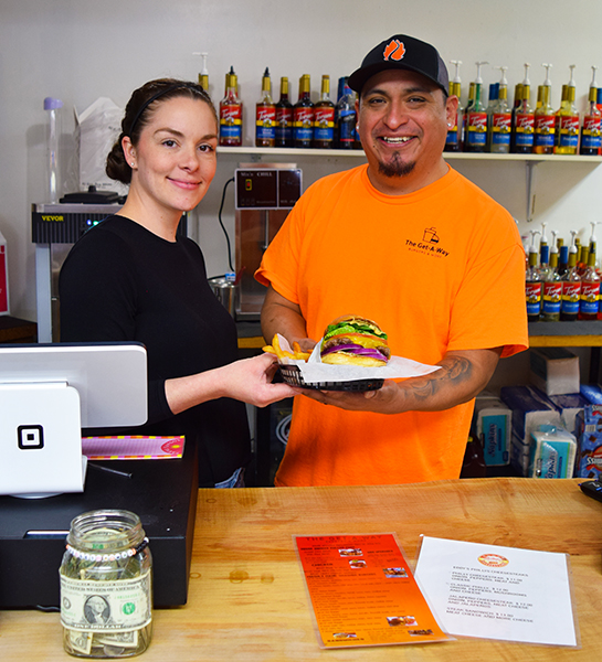 The Get-A-Way owner Ashley Yardley, left, shows off one of their signature smash-burgers with husband Adalid Garcia at the restaurant’s new location at 218 Santiam Blvd., in Mill City. Janet Patterson