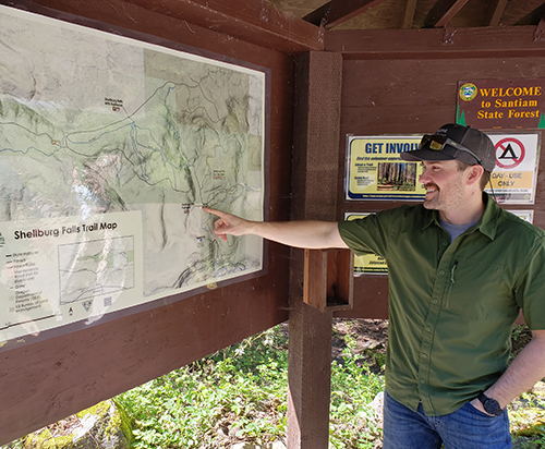Joe Offer, the recreation programs manager with the ODF, points out some of the new features of the Shellburg Falls area at a map kiosk in the main parking lot for trail users. James Day
